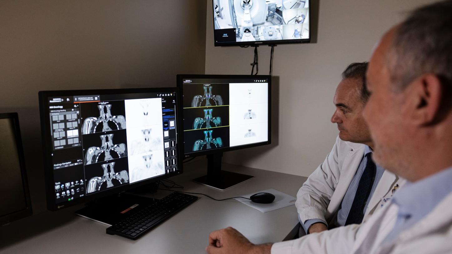 Koutsikos and colleague study scans.