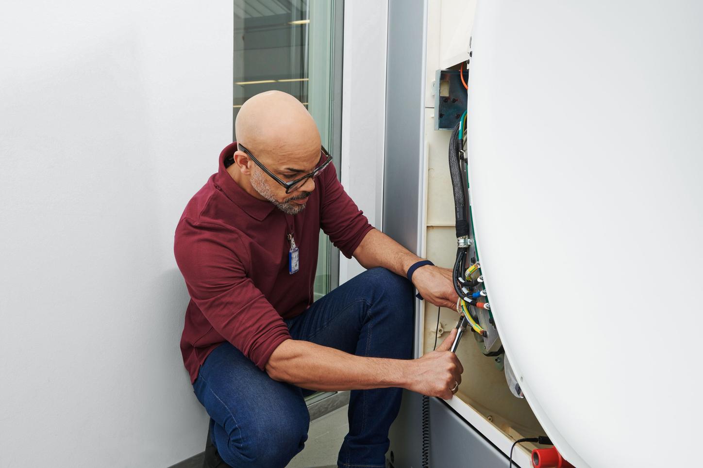 Customer Service: Man fixing a maintenance issue on site