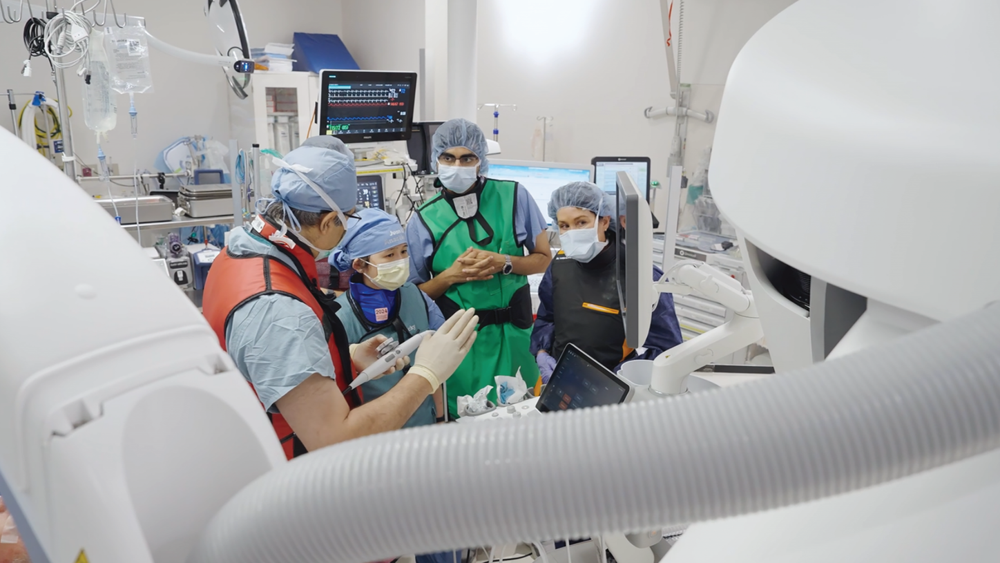 C-arm imaging machine (the curved X-ray gantry used in cath labs)