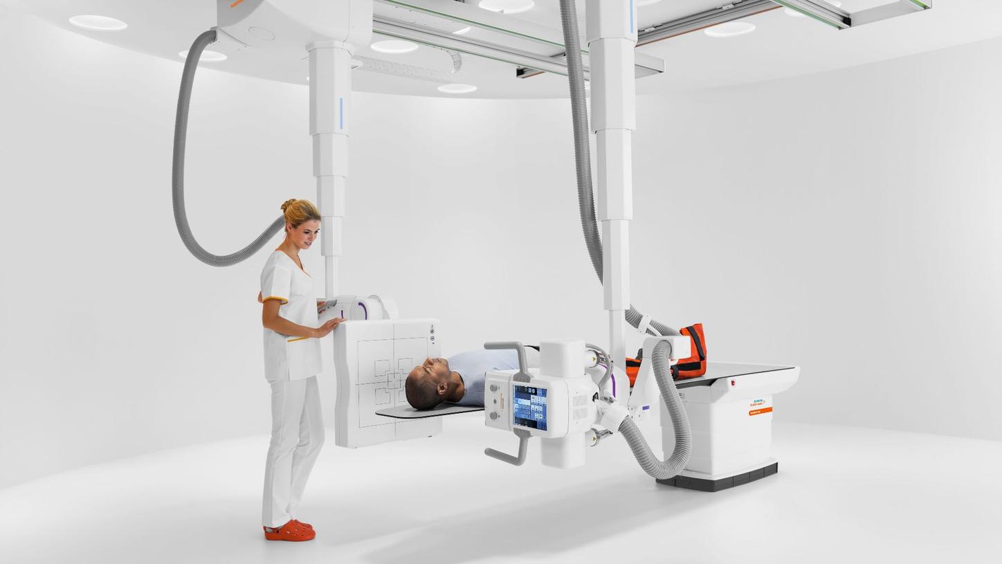 Doctor examining patient with Multitom Rax