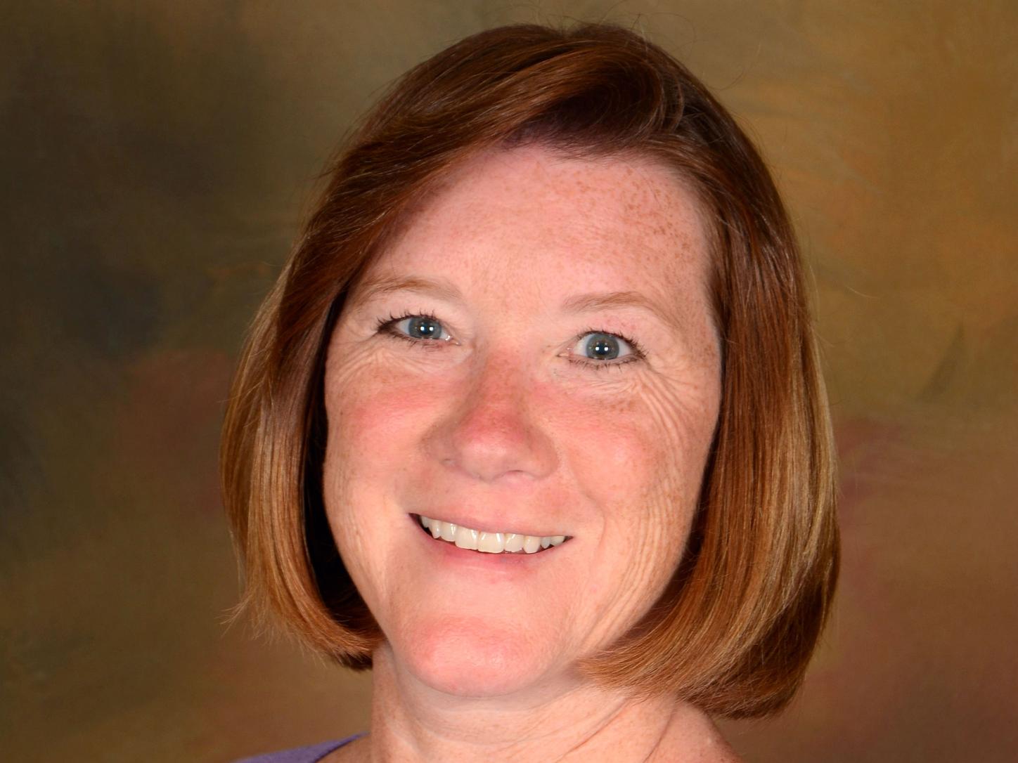 Portrait of Susan Dawson, webinar speaker, smiling at the camera.