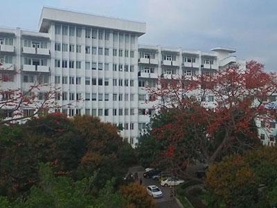 Exterior of Zhongshan People's Hospital, showing a multistory hospital building surrounded by trees.