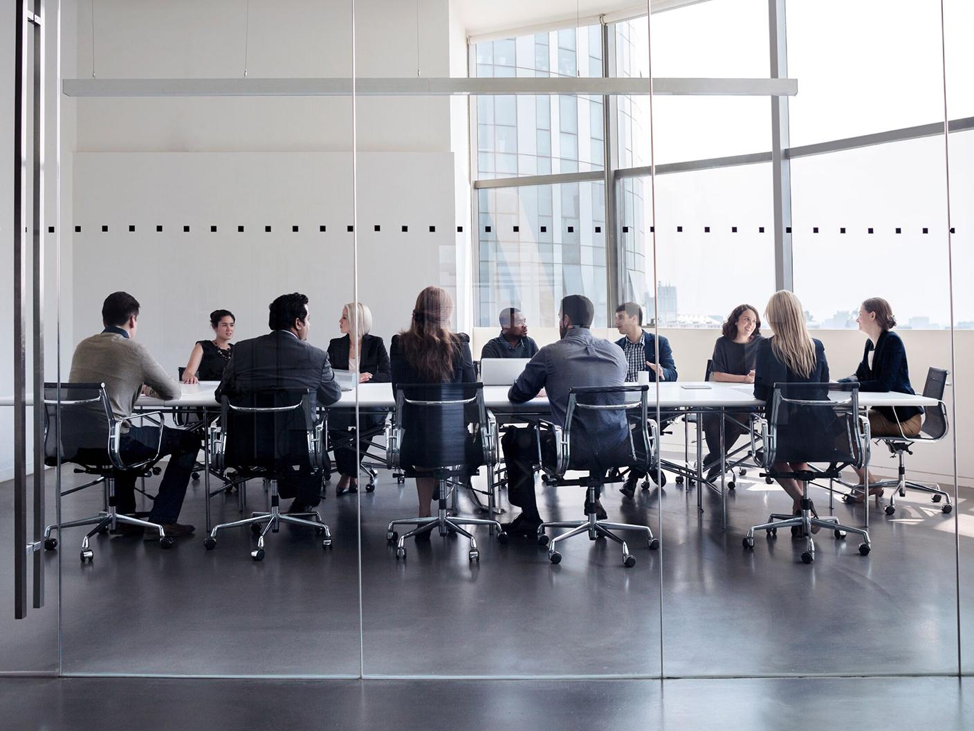 Consultants and healthcare providers in a boardroom discussing plans for digital transformation.