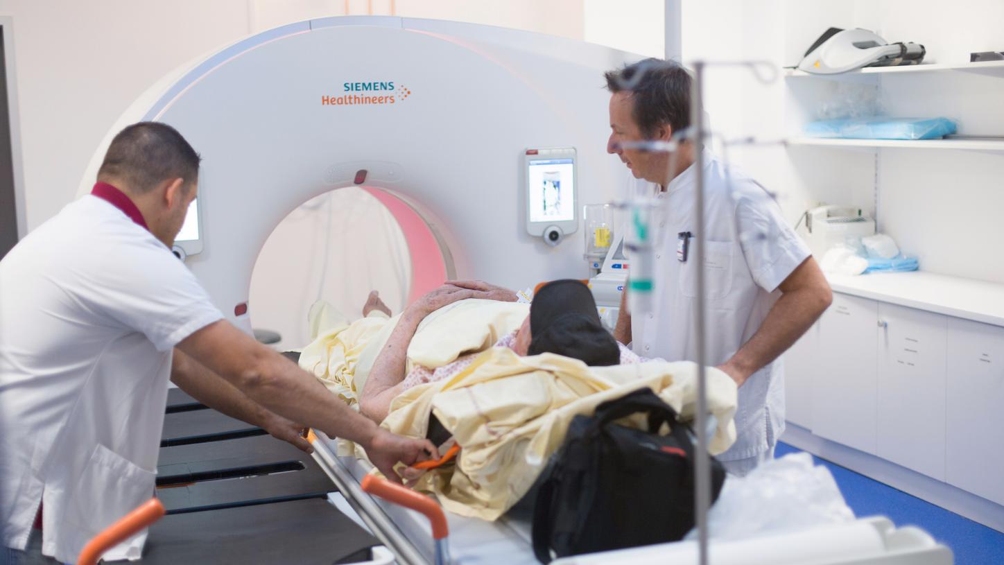 Joël Greffier, Medical Physicist, and his colleague prepare the patient for a CT scan. 