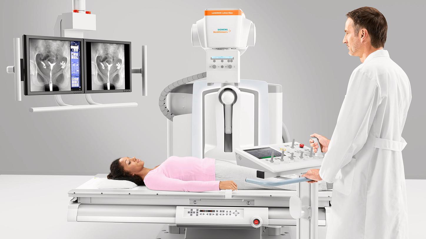 Pediatric patient undergoing procedure on LUMINOS Lotus Max with radiologist performing the clinical examination.