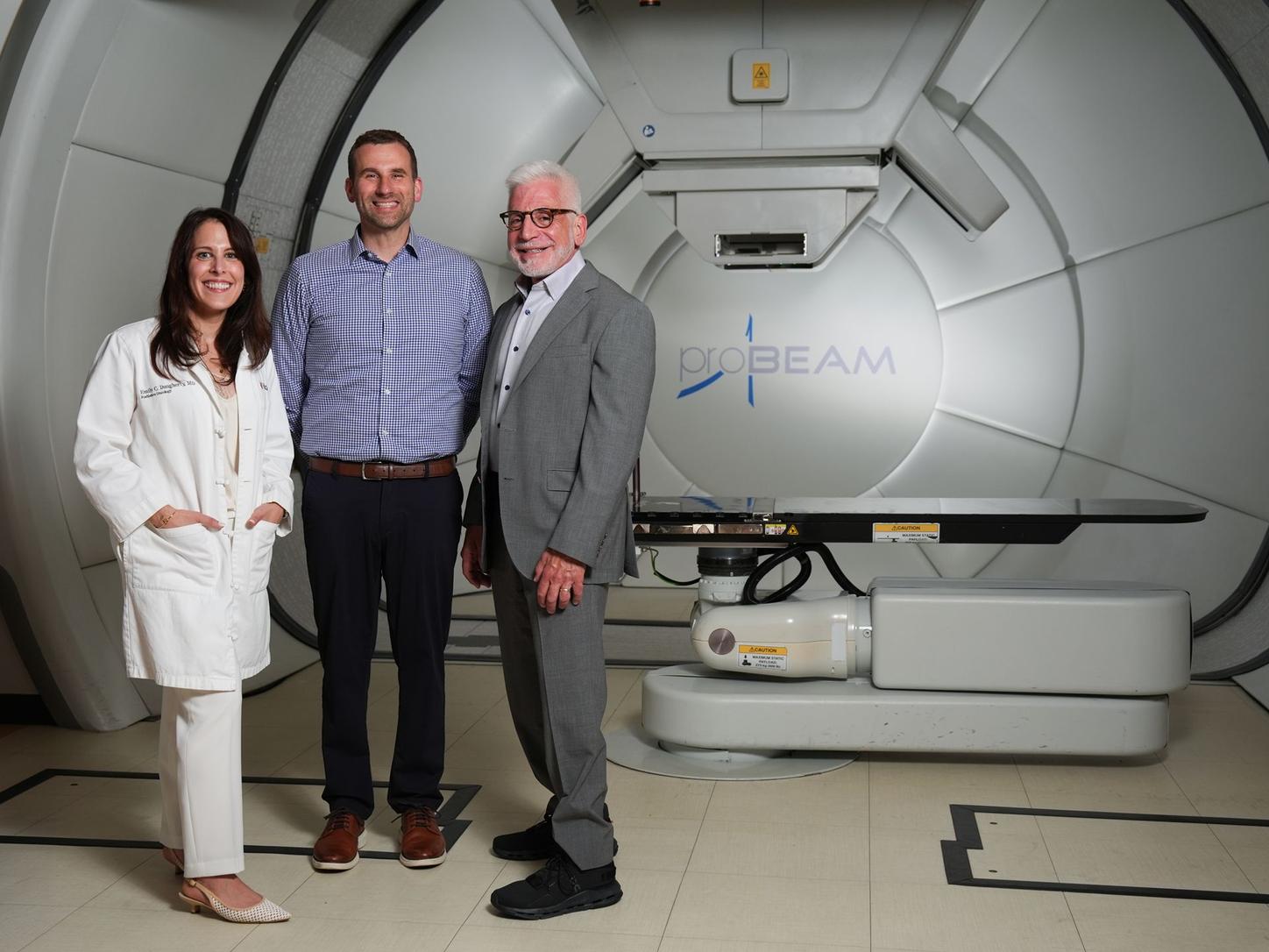 Emily Daugherty, MD, Anthony Mascia, PhD, and John Perentesis, MD in front of the ProBeam