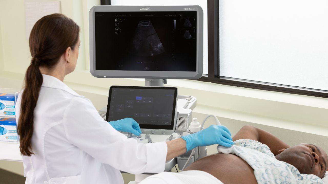 Doctor using ACUSON Juniper for an abdominal ultrasound exam