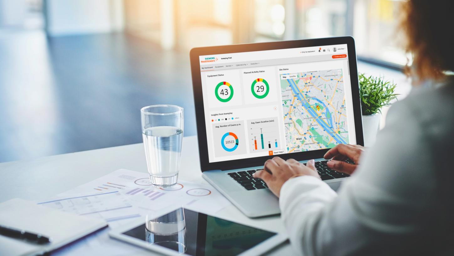 Person using a laptop displaying a healthcare analytics dashboard.