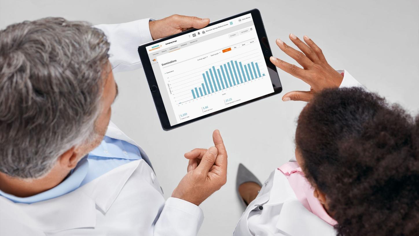 Two doctors examining teamplay on a tablet