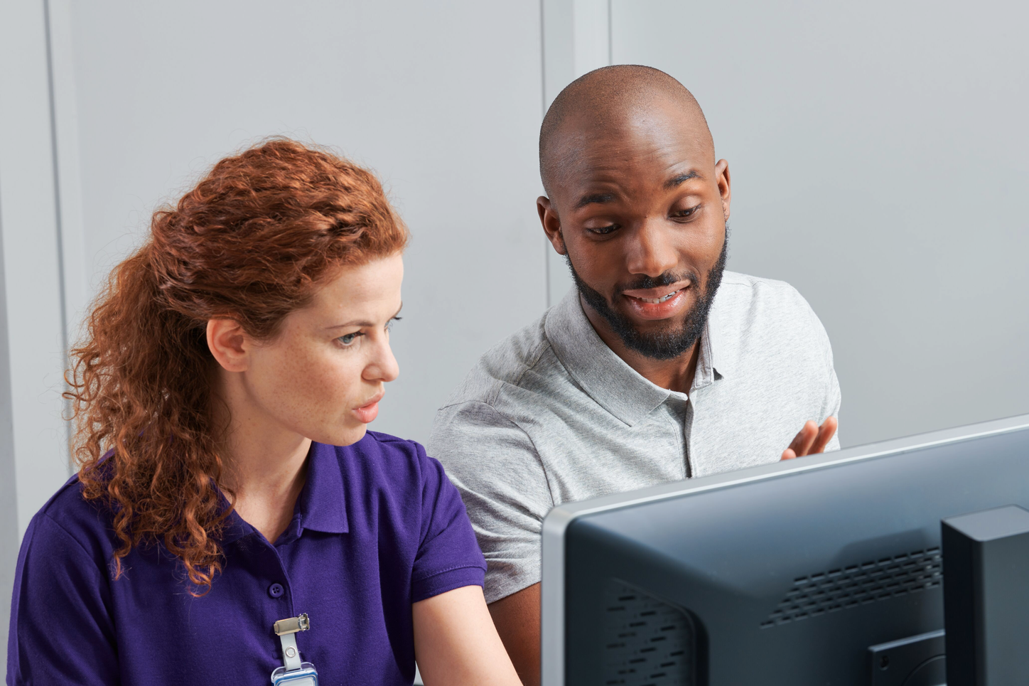 Man and woman looking at computer in hospital