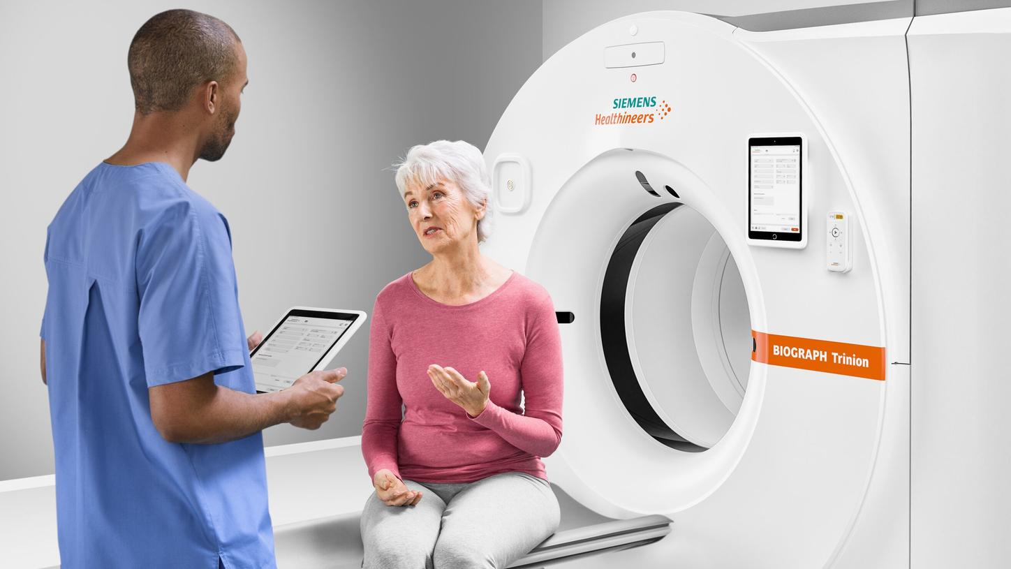 Doctor discussing with a patient sitting on the Biograph Trinion