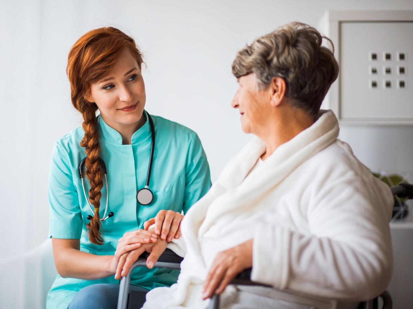 Doctor sitting next to patient