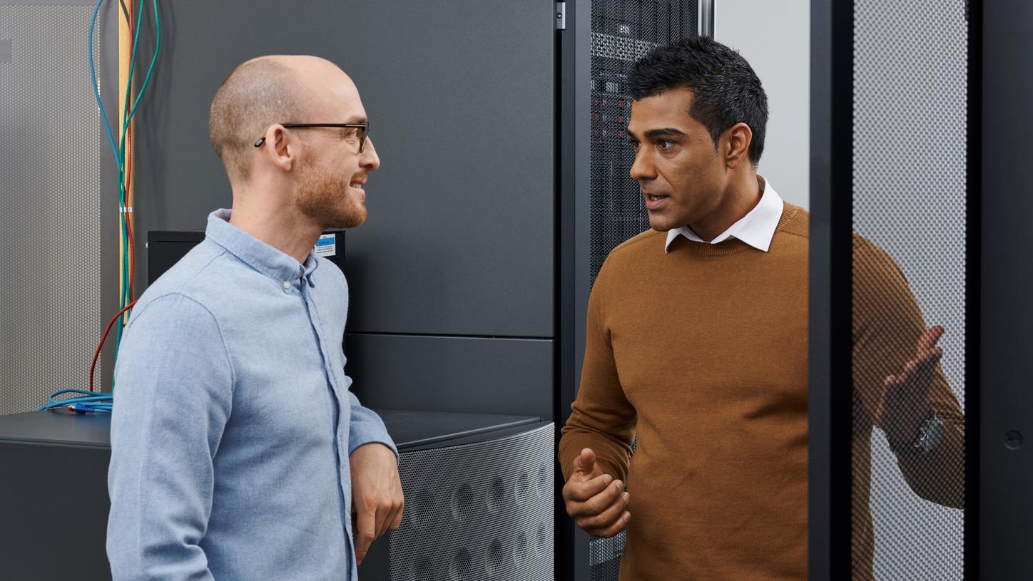 Men discussing in front of server