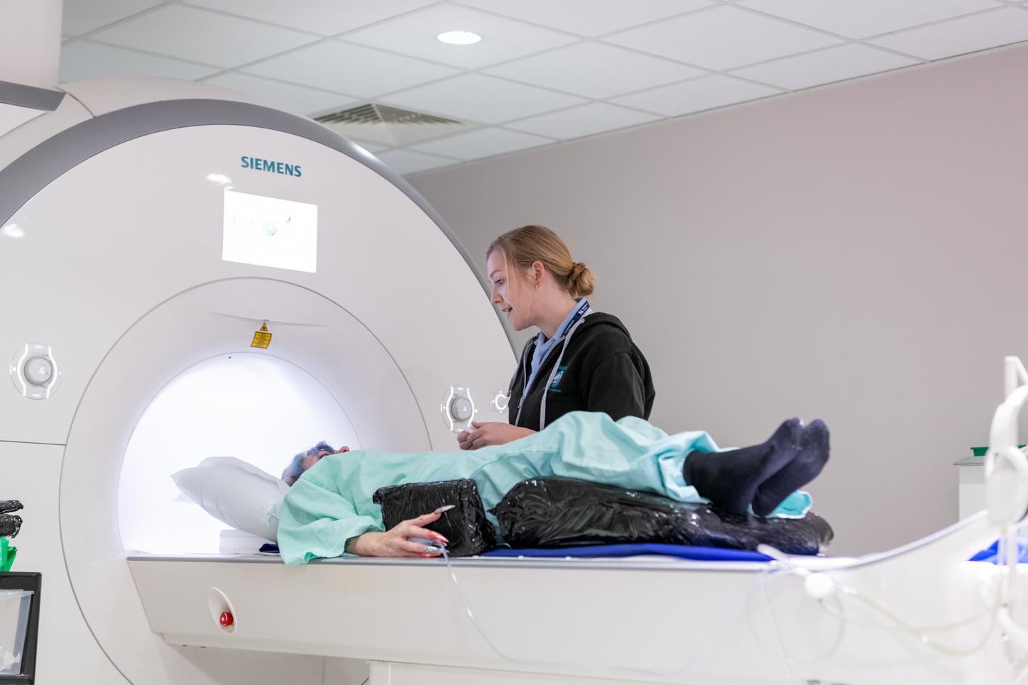A patient lies on a table being prepared for an MRI scan. Siemens Healthineers technology has been at the heart of the groundbreaking UK Biobank study since the project’s inception more than a decade ago. Photo credit: UK Biobank / Dave Guttridge