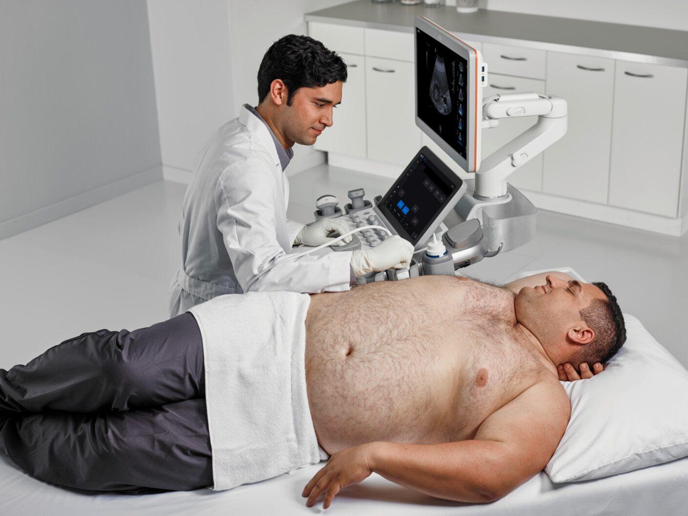 A doctor administering BioAcoustic Technology to a patient