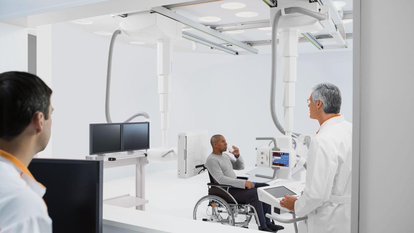 Doctors examining patient with Multitom Rax 