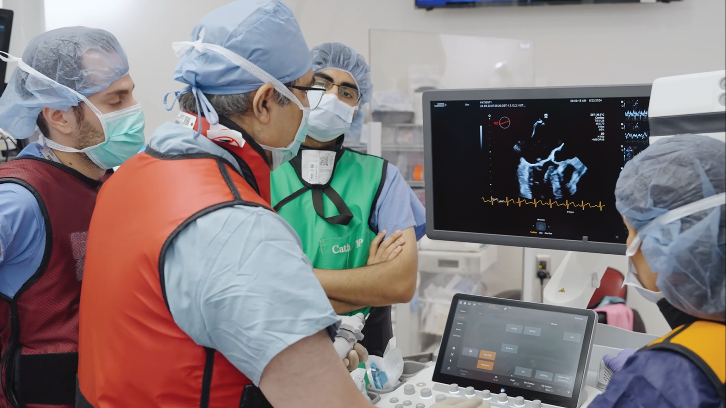 clinicians (in surgical caps/gowns) working at imaging monitors of ACUSON Origin