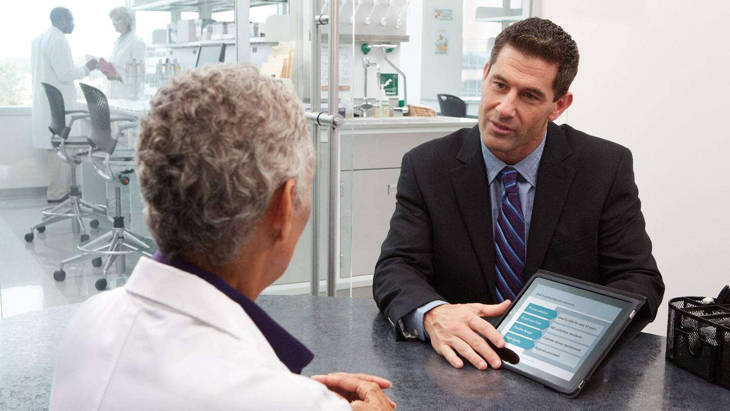Two healthcare professionals in discussion during lab consulting
