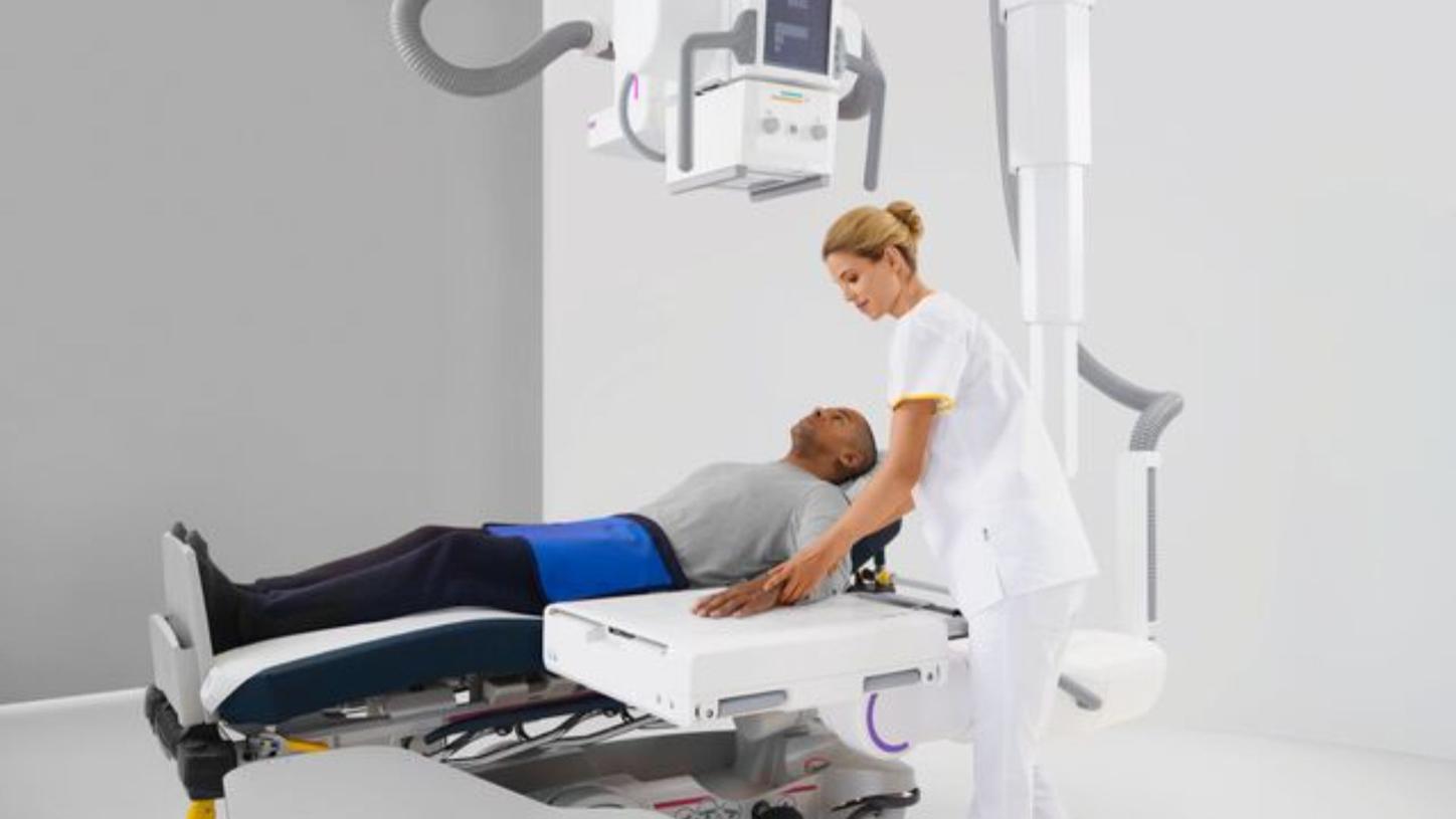 Doctor examining patient with Multitom Rax 