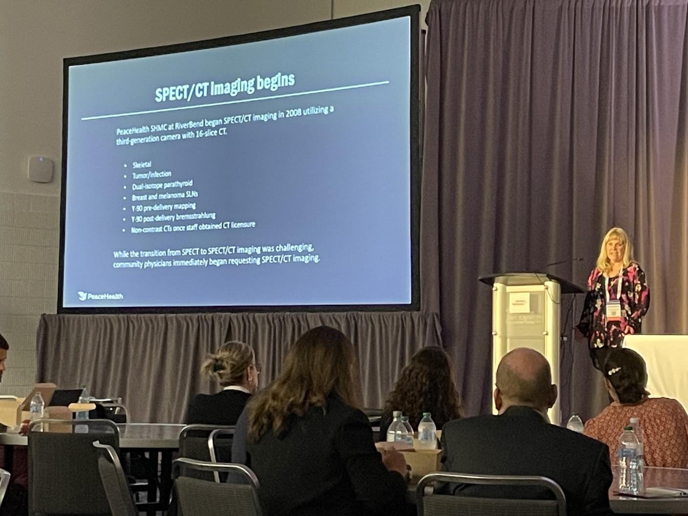 Bamford begins the luncheon symposium with a presentation on Symbia Pro.specta SPECT/CT for theranostics.