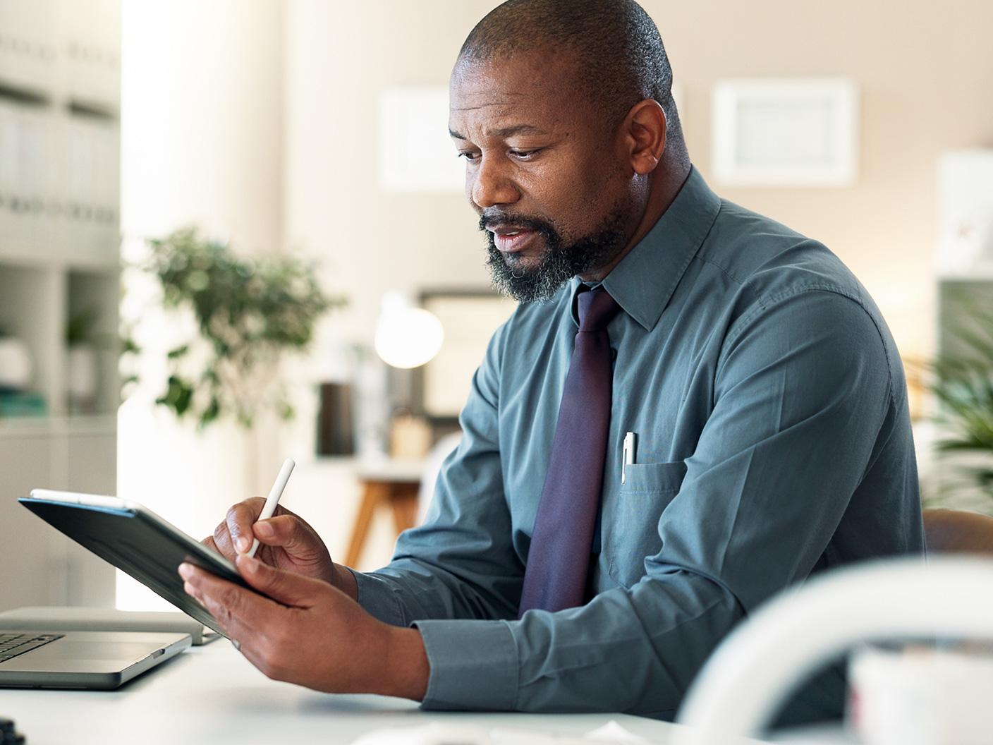 Healthcare professional using a tablet at a desk to review and purchase point-of-care solutions online