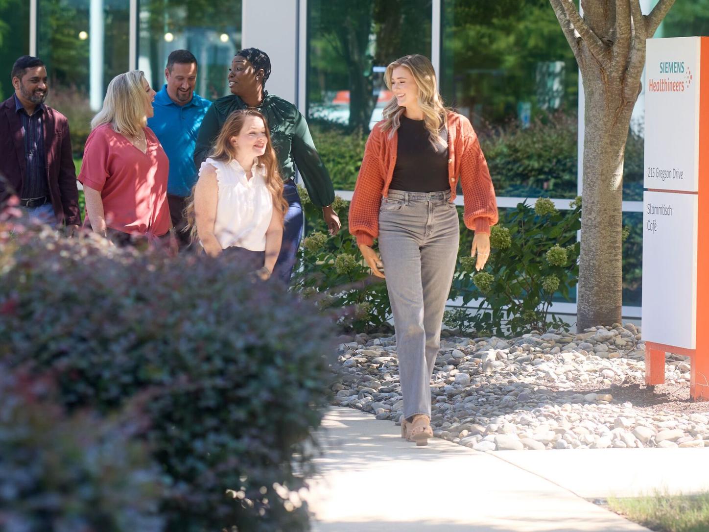 Employees outside a Siemens Healthineers bulding