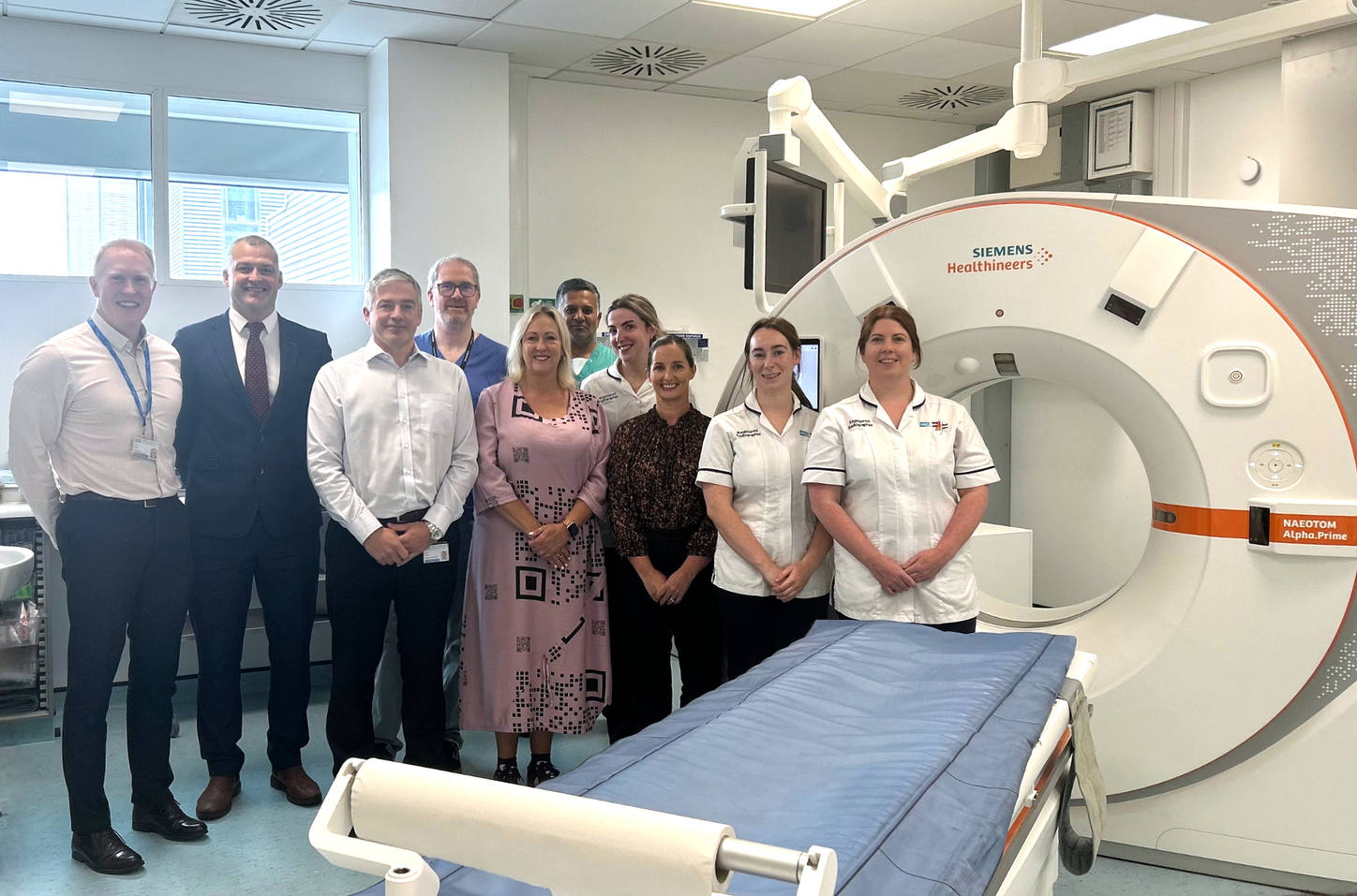 Image caption: Pictured with the NAEOTOM Alpha photon-counting CT scanner at Royal Victoria Hospital are [from left to right] Gary Burke – interim imaging services manager at Royal Victoria Hospital, Michael Ennis – account manager, Philip Frizzell – regional operations manager at Siemens Healthineers Great Britain and Ireland, Graham Smith – consultant radiologist, Marion Mulholland – director, Raghu Sathya – consultant radiologist, Niamh Fox - radiographer, Siobhan Speirs – imaging site lead, Rachel Mccaul – radiographer and Daniella O’Hare - lead CT radiographer at Royal Victoria Hospital. The scanner brings a new generation of CT imaging technology to patients across Northern Ireland.