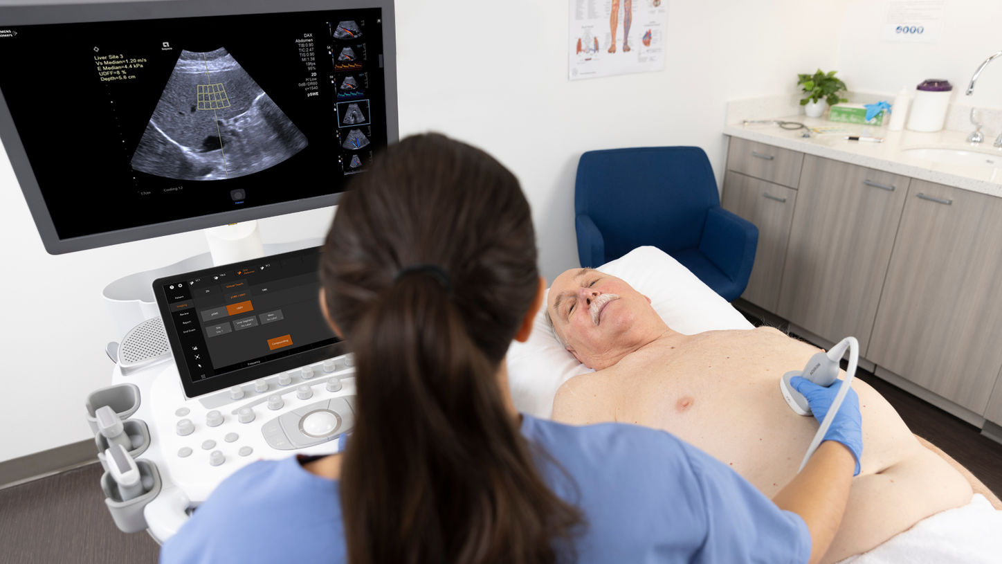Man receiving an abdominal ultrasound exam with the DAX transducer