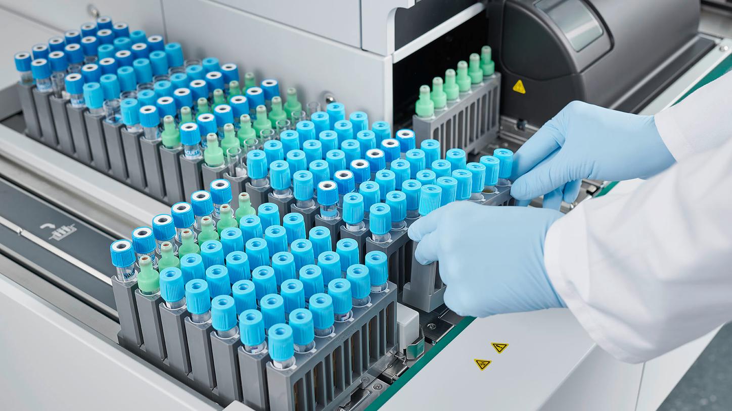 Lab tech loading tubes on CN Series System from Siemens Healthineers