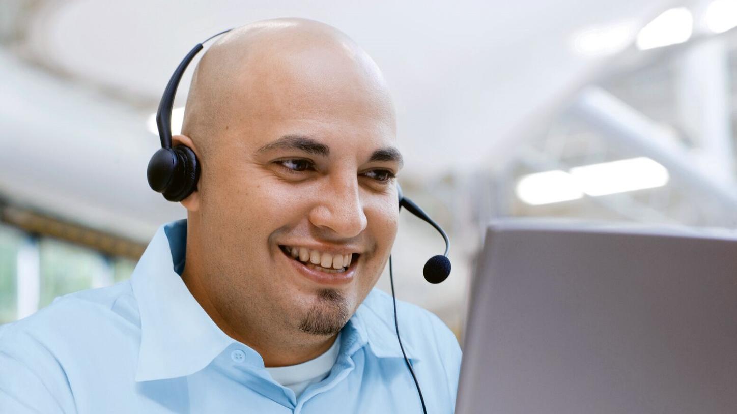Man with headset on computer