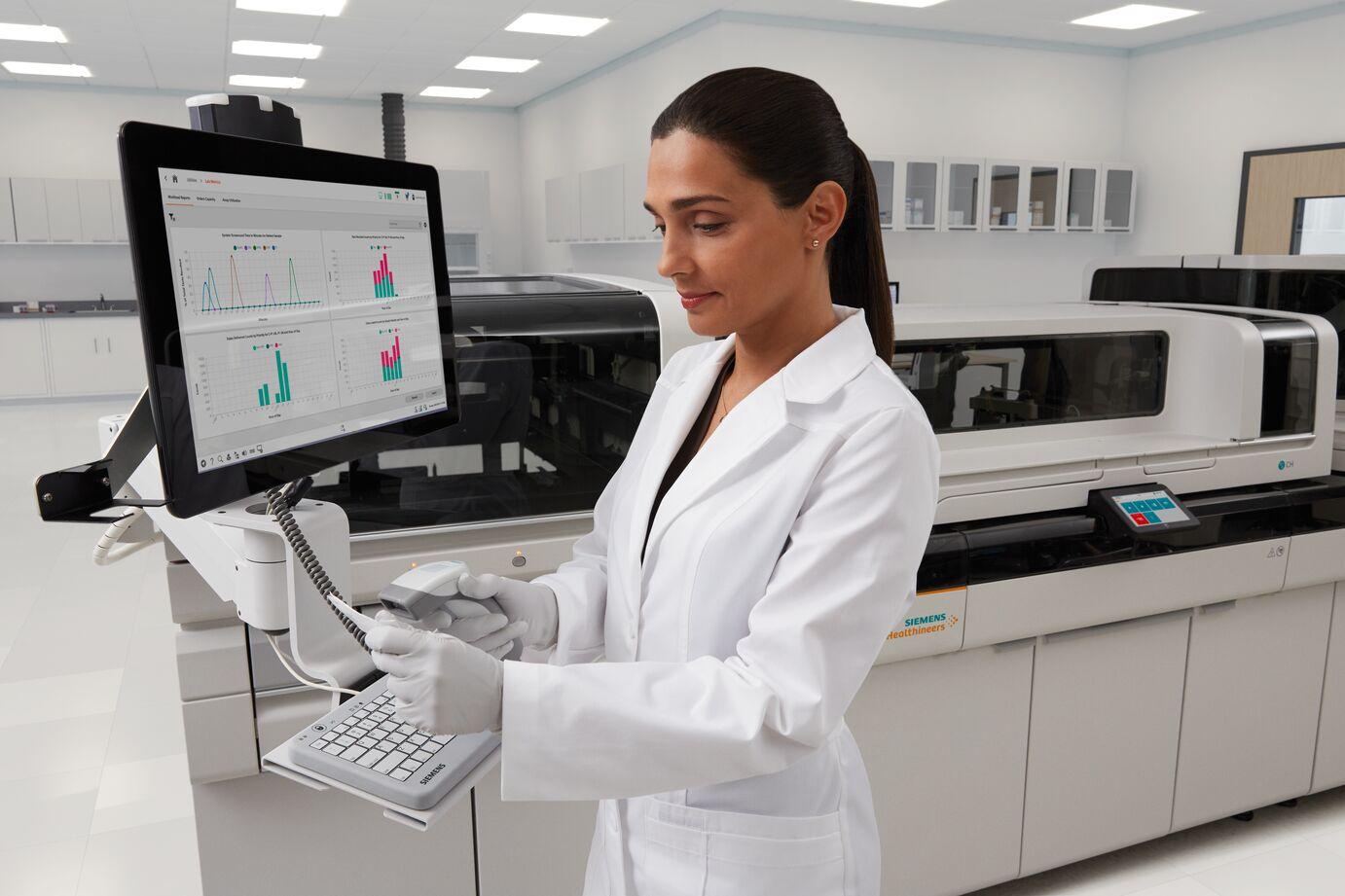 Lab tech in front of an Atellica Solution 