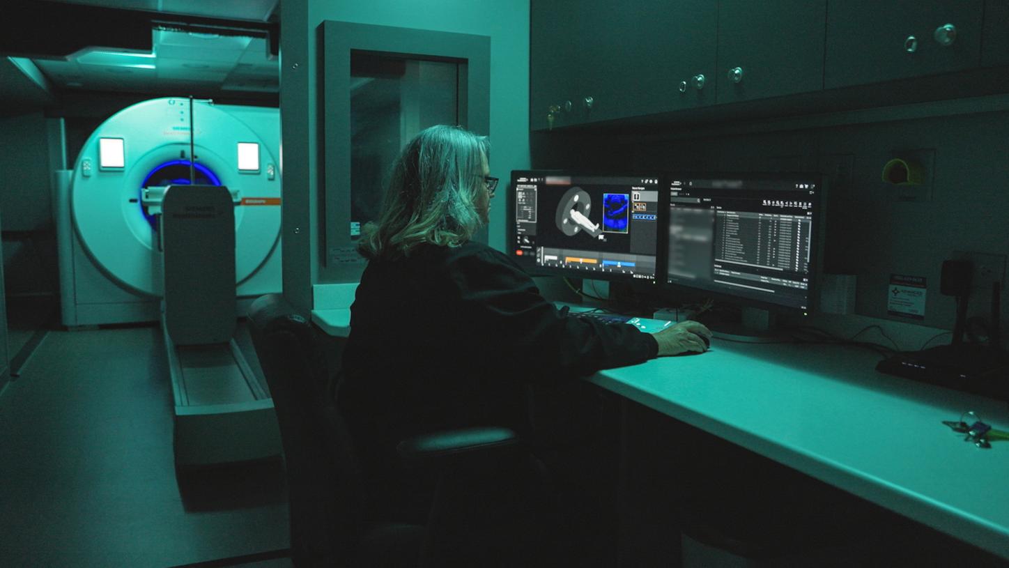 A mobile unit featuring the Siemens Healthineers Biograph Trinion PET/CT showcasing moodlighting effects.