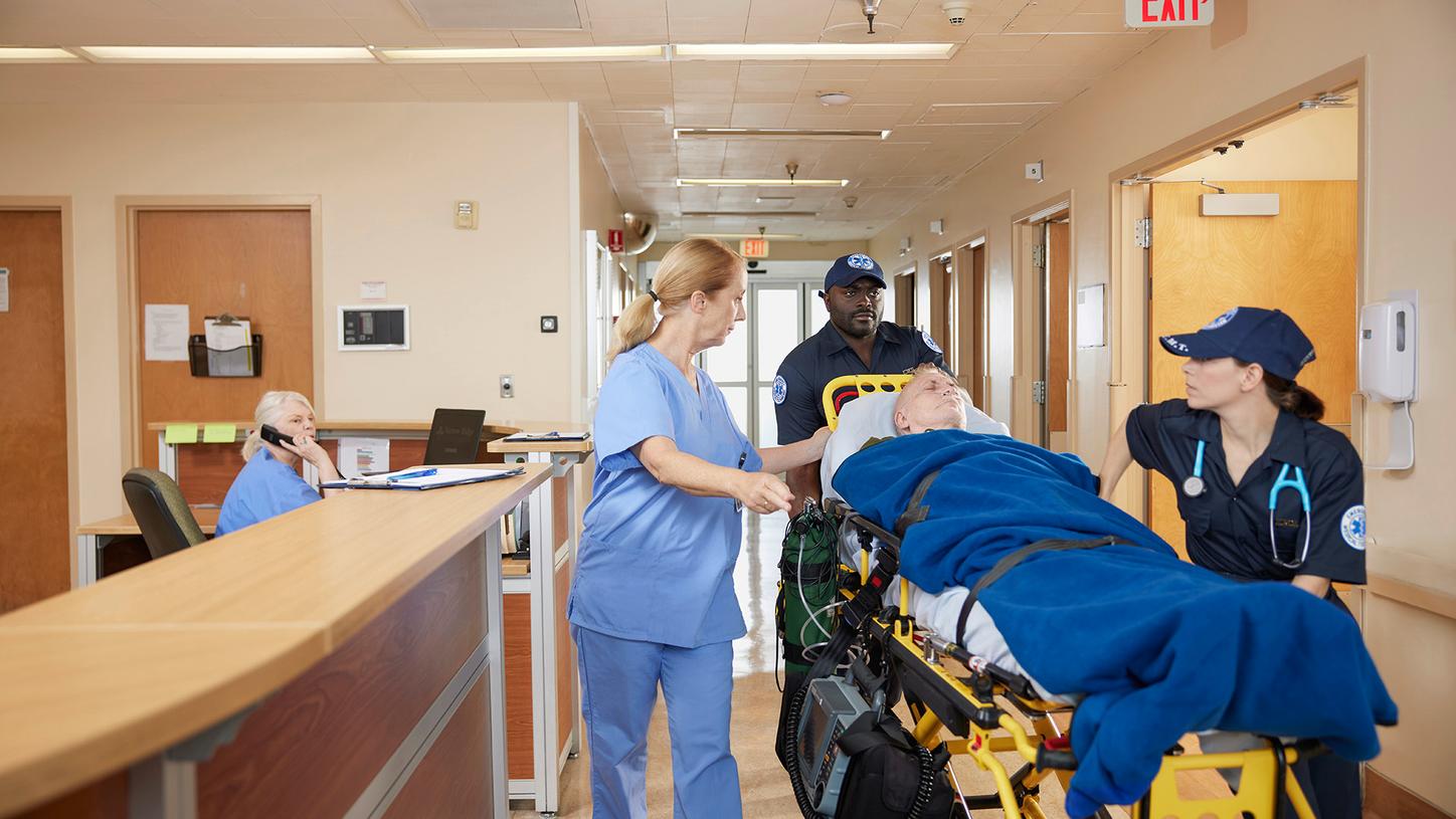 Pharmacist providing information and assistance to a patient at a pharmacy counter