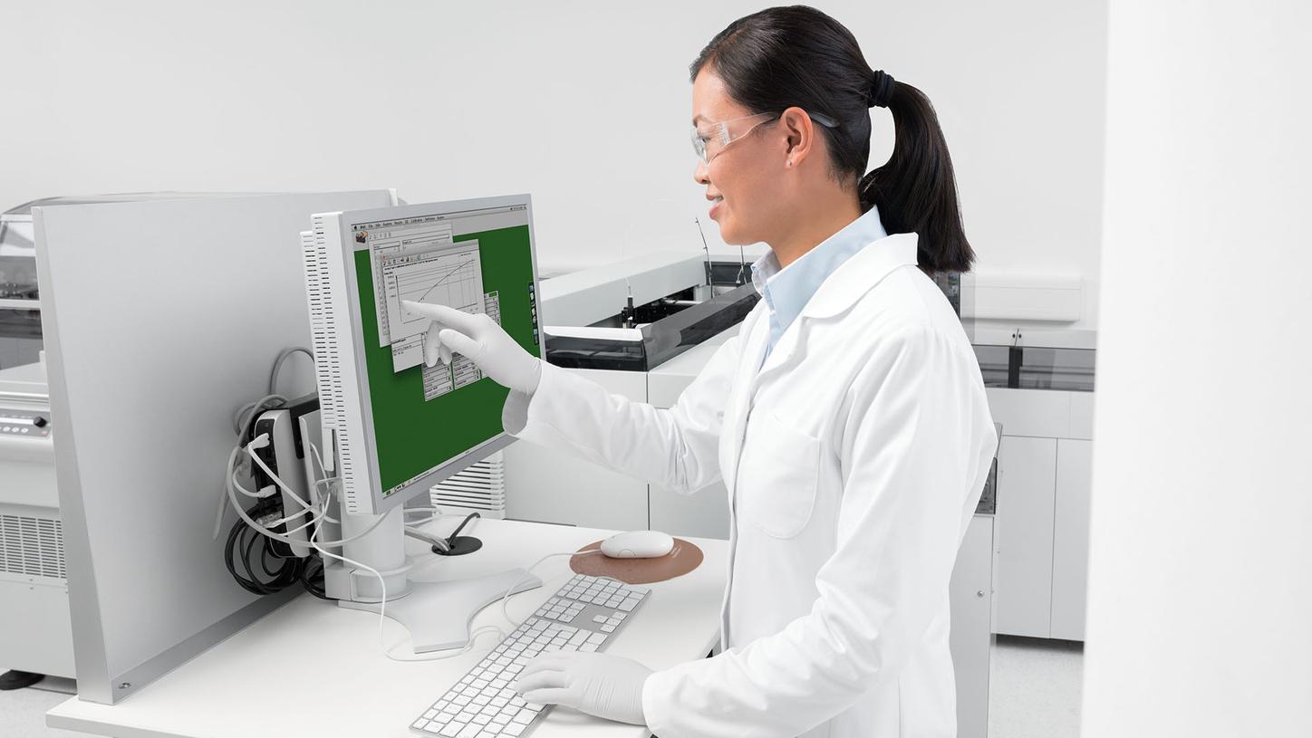 Laboratory professional using the BN II System user interface for plasma protein testing