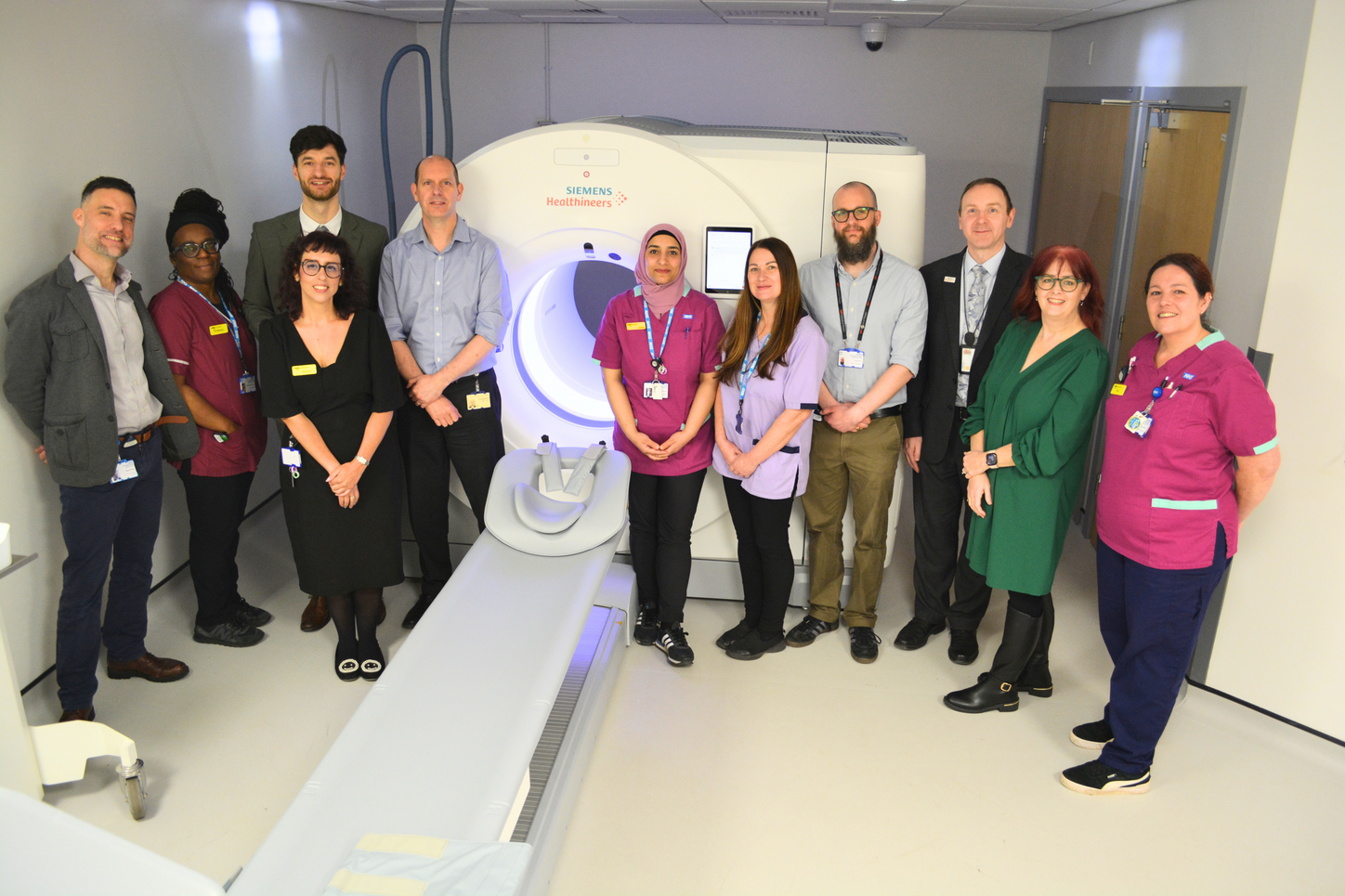 Image caption: [From left to right] Matthew Ward – higher principal clinical scientist, Eleanor Duncan – senior radiographer, Diana Almeida – clinical and operational lead PET-CT at The Clatterbridge Cancer Centre, Oleh Stakhiv – MI product specialist at Siemens Healthineers Great Britain and Ireland, Carl Rowbottom – director of Physics, Zunaira Rasheed – senior radiographer, Nichola Johnson – radiology assistant, Fergus Dunn – senior clinical scientist, Graeme Wells – regional sales manager, Monica Pinson – MI applications specialist at Siemens Healthineers Great Britain and Ireland, Ingrid Clark – diagnostic radiographer at The Clatterbridge Cancer Centre, standing with the first Biograph Trinion PET-CT system from Siemens Healthineers in the UK.  