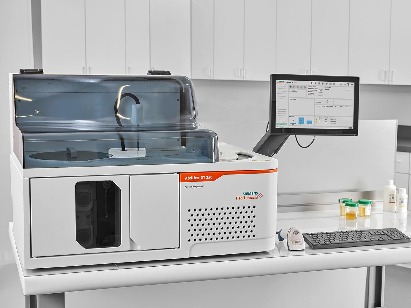 Atellica DT 250 Analyzer on a laboratory bench with connected workstation and sample containers.